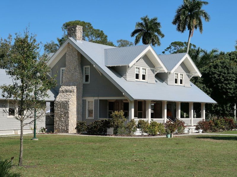Stone and shingle home with a covered front porch